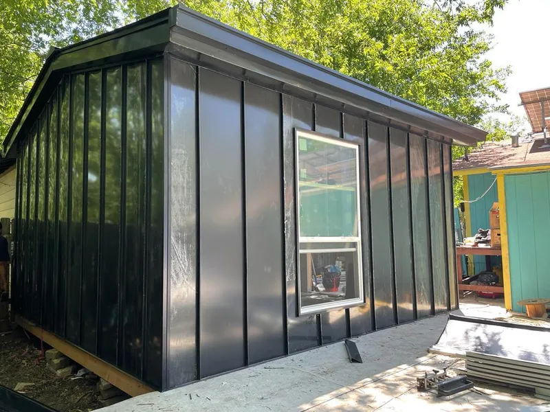 Black standing seam metal wall panels for Roof Inspection in Wright